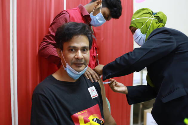 February 9, 2021: A man is taking the Oxford-AstraZeneca s COVID-19 vaccine produced by the Serum Institute of India on the third day of the first phase of vaccination in Dhaka, bangladesh. - ZUMAh355 20210209_zip_h355_004 Copyright: xMd.xRakibulxHasanx