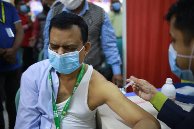 February 9, 2021: A government employee is taking the Oxford-AstraZeneca s COVID-19 vaccine produced by the Serum Institute of India on the third day of the first phase of vaccination in Dhaka, bangladesh. - ZUMAh355 20210209_zip_h355_005 Copyright: xMd.xRakibulxHasanx