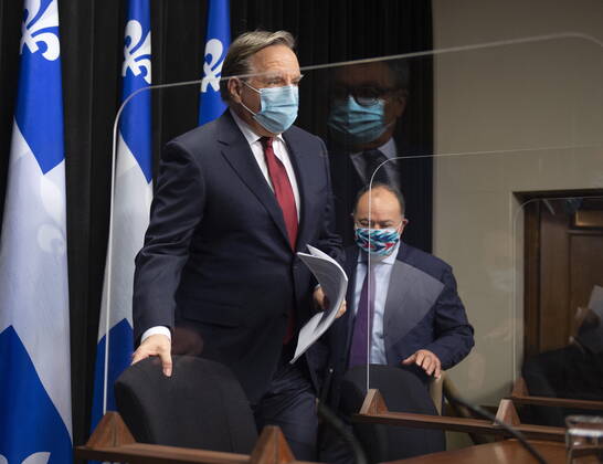 February 9, 2021, QUEBEC, PQ, Canada: Quebec Premier Francois Legault, left, andQuebec Health Minister Christian Dube, right walk in a news conference on the COVID-19 pandemic, Tuesday, February 9, 2021 at the legislature in Quebec City. Horacio Arruda, Quebec director of National Public Health, is reflected in the plexiglass QUEBEC Canada - ZUMAc35_ 20210209_zaf_c35_016 Copyright: xJacquesxBoissinotx
