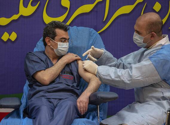 (210209) -- TEHRAN, Feb. 9, 2021 -- A healthcare worker receives the COVID-19 vaccine at a hospital in Tehran, Iran, on Feb. 9, 2021. Iran on Tuesday started the nationwide vaccination campaign against COVID-19, using Russia s Sputnik V jabs, official news agency IRNA reported. (Photo by Xinhua) IRAN-TEHRAN-COVID-19-VACCINATION CAMPAIGN-START AhmadxHalabisaz 