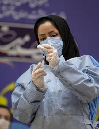 (210209) -- TEHRAN, Feb. 9, 2021 -- A healthcare worker prepares to give injection of the COVID-19 vaccine at a hospital in Tehran, Iran, on Feb. 9, 2021. Iran on Tuesday started the nationwide vaccination campaign against COVID-19, using Russia s Sputnik V jabs, official news agency IRNA reported. (Photo by Xinhua) IRAN-TEHRAN-COVID-19-VACCINATION CAMPAIGN-START AhmadxHalabisaz 