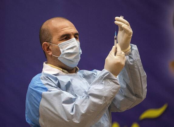 (210209) -- TEHRAN, Feb. 9, 2021 -- A healthcare worker prepares to give injection of the COVID-19 vaccine at a hospital in Tehran, Iran, on Feb. 9, 2021. Iran on Tuesday started the nationwide vaccination campaign against COVID-19, using Russia s Sputnik V jabs, official news agency IRNA reported. (Photo by Xinhua) IRAN-TEHRAN-COVID-19-VACCINATION CAMPAIGN-START AhmadxHalabisaz 