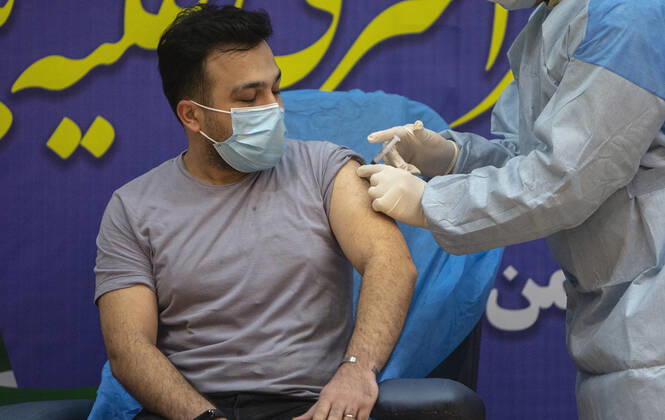 (210209) -- TEHRAN, Feb. 9, 2021 -- A man receives the COVID-19 vaccine at a hospital in Tehran, Iran, on Feb. 9, 2021. Iran on Tuesday started the nationwide vaccination campaign against COVID-19, using Russia s Sputnik V jabs, official news agency IRNA reported. (Photo by Xinhua) IRAN-TEHRAN-COVID-19-VACCINATION CAMPAIGN-START AhmadxHalabisaz 