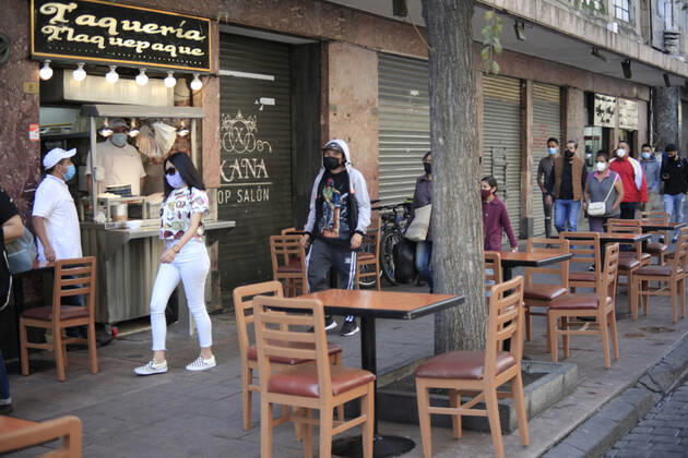 February 9, 2021, Mexico City, Mexico City, Mexico: A person sits at a table outside of a restaurant, after closed several days due red alert by Covid. The Mexican Government allowed the reopening of restaurants with outdoor service, , as an attempt to prevent spread of the Virus February 9, 2021 in Mexico City, Mexico Mexico City Mexico - ZUMAe321 20210209_zia_e321_014 Copyright: xAngelxMoralesxRizox