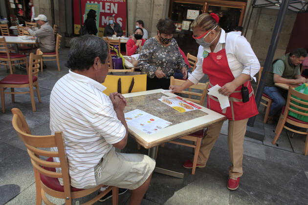 February 9, 2021, Mexico City, Mexico City, Mexico: A person sits at a table outside of a restaurant, after closed several days due red alert by Covid. The Mexican Government allowed the reopening of restaurants with outdoor service, , as an attempt to prevent spread of the Virus February 9, 2021 in Mexico City, Mexico Mexico City Mexico - ZUMAe321 20210209_zia_e321_032 Copyright: xAngelxMoralesxRizox