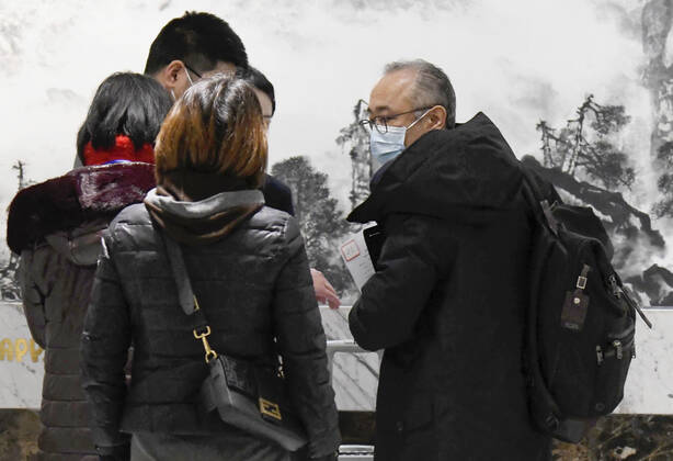 WHO team s departure after Wuhan mission Ken Maeda (R), a member of the World Health Organization s team investigating the origins of the coronavirus pandemic, is pictured at Wuhan s airport in China s Hubei Province on Feb. 10, 2021, at the end of the WHO mission. 