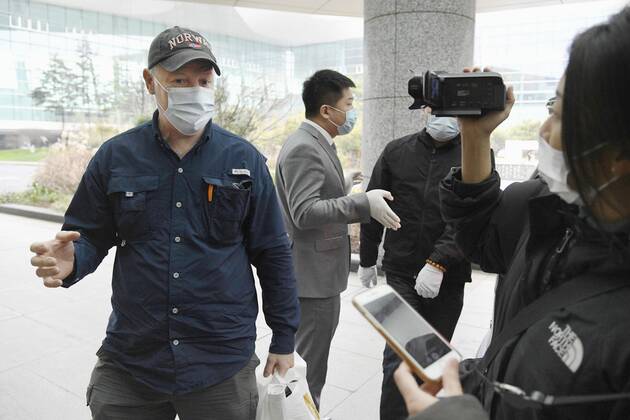 WHO team s departure after Wuhan mission Peter Daszak (L), a member of the World Health Organization s team tasked with investigating the origins of the coronavirus pandemic, speaks at Wuhan s airport in China on Feb. 10, 2021, at the end of the WHO mission. 