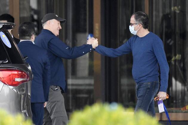 WHO team s departure after Wuhan mission Peter Ben Embarek (R) and Peter Daszak of a World Health Organization team shake hands before leaving their hotel for the airport at the end of their mission to investigate the origins of the coronavirus pandemic in Wuhan, China, on Feb. 10, 2021. 