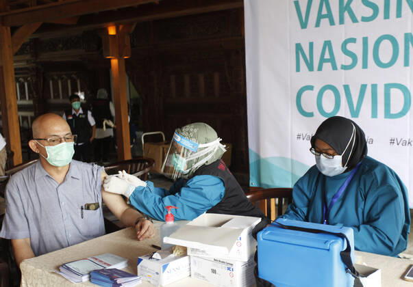 Indonesia s COVID-19 Mass Vaccination A health worker vaccinates elderly health workers during COVID-19 mass vaccination for medical workers and elderly people in Bogor, West Java on February 11, 2021. (Photo by Adrian INA Photo Agency) 