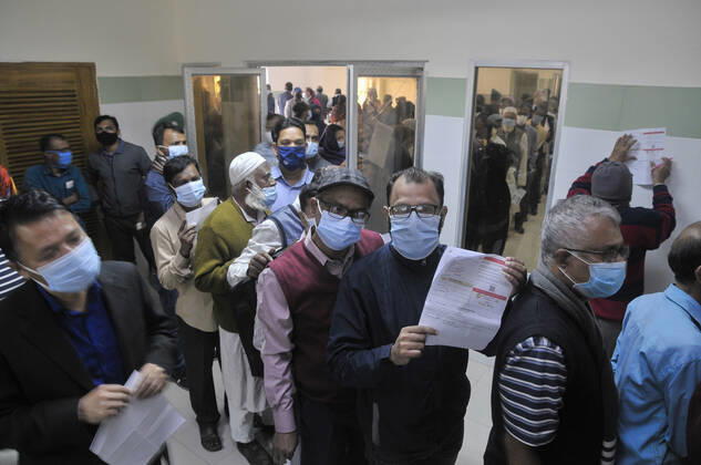 February 11, 2021: People gathered in line to take Covid 19 , vaccination at M A G Osmani Medical College and Hospital, Vaccination Center, Sylhet, Bangladesh - ZUMAr143 20210211_zap_r143_017 Copyright: xMdxRafayatxHaquexKhanx
