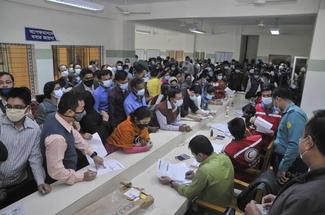 February 11, 2021: People gathered in line to take Covid 19 , vaccination at M A G Osmani Medical College and Hospital, Vaccination Center, Sylhet, Bangladesh - ZUMAr143 20210211_zap_r143_022 Copyright: xMdxRafayatxHaquexKhanx
