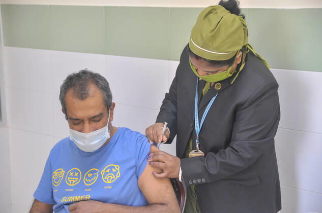 February 11, 2021: Health workers vaccinates a man against coronavirus (COVID-19) during the first-stage coronavirus vaccination at MAG Osmani Medical College & Hospital- Vaccination Center, Syllhet, Bangladesh. - ZUMAr143 20210211_zap_r143_026 Copyright: xMdxRafayatxHaquexKhanx