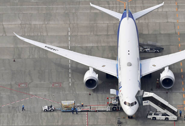 1st batch of Pfizer COVID-19 vaccine arrives in Japan Photo taken from a Kyodo News helicopter on Feb. 12, 2021, shows cargo being unloaded at Narita airport near Tokyo from an airplane that transported from Brussels the first batch to arrive in Japan of the coronavirus vaccine developed by U.S. pharmaceutical giant Pfizer Inc. 