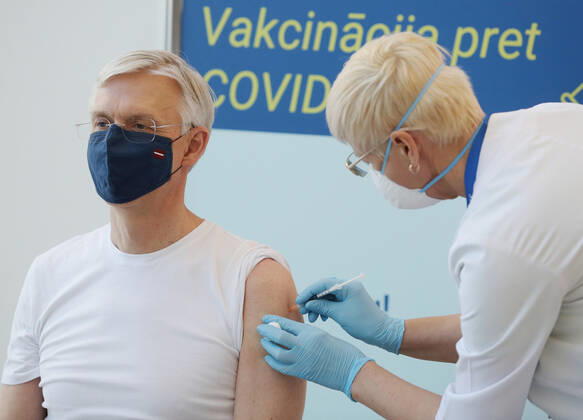 (210211) -- RIGA, Feb. 11, 2021 -- Latvian Prime Minister Krisjanis Karins (L) receives the COVID-19 vaccine at a hospital in Riga, Latvia, on Feb. 11, 2021. Latvia s top state officials whose office duties involve ensuring national security and the functioning of the state received the first dose of the coronavirus vaccine on Thursday, local media reported. (Photo by Xinhua) LATVIA-RIGA-LEADERS-CORONAVIRUS VACCINE EdijsxPalens 