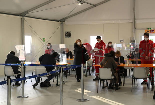 (210211) -- ROME, Feb. 11, 2021 -- People fill out forms before receiving the COVID-19 vaccine at a vaccination center at Rome s Fiumicino Airport, Italy, on Feb. 11, 2021. About one month after easing most restrictions on people s movements, Italy maintained a downward trend in active coronavirus infections, the latest official data showed. The three coronavirus vaccines authorized in Italy -- Pfizer BioNTech, Moderna and AstraZeneca -- have been administered to almost 2.8 million people, according to the data by Coronavirus Emergency Commissioner Domenico Arcuri s office. (Photo by Xinhua) ITALY-ROME-AIRPORT-VACCINATION AlbertoxLingria 
