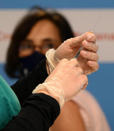 (210211) -- ROME, Feb. 11, 2021 -- A medical worker prepares to give injection of the COVID-19 vaccine at a vaccination center at Rome s Fiumicino Airport, Italy, on Feb. 11, 2021. About one month after easing most restrictions on people s movements, Italy maintained a downward trend in active coronavirus infections, the latest official data showed. The three coronavirus vaccines authorized in Italy -- Pfizer BioNTech, Moderna and AstraZeneca -- have been administered to almost 2.8 million people, according to the data by Coronavirus Emergency Commissioner Domenico Arcuri s office. (Photo by Xinhua) ITALY-ROME-AIRPORT-VACCINATION AlbertoxLingria 