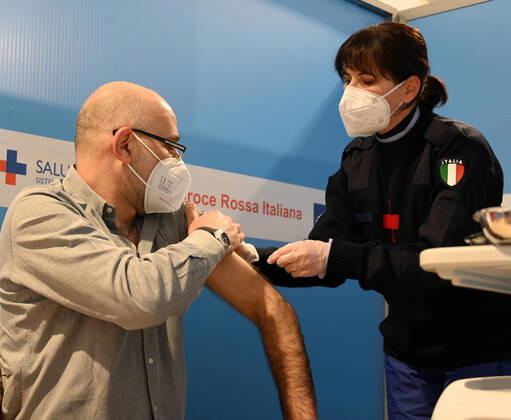 (210211) -- ROME, Feb. 11, 2021 -- A medical worker receives the COVID-19 vaccine at a vaccination center at Rome s Fiumicino Airport, Italy, on Feb. 11, 2021. About one month after easing most restrictions on people s movements, Italy maintained a downward trend in active coronavirus infections, the latest official data showed. The three coronavirus vaccines authorized in Italy -- Pfizer BioNTech, Moderna and AstraZeneca -- have been administered to almost 2.8 million people, according to the data by Coronavirus Emergency Commissioner Domenico Arcuri s office. (Photo by Xinhua) ITALY-ROME-AIRPORT-VACCINATION AlbertoxLingria 