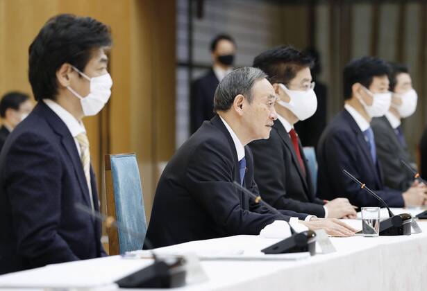 Japan PM Suga at coronavirus meeting Japanese Prime Minister Yoshihide Suga (2nd from L) speaks during a meeting of the government s anti-coronavirus task force at his office in Tokyo on Feb. 12, 2021. 