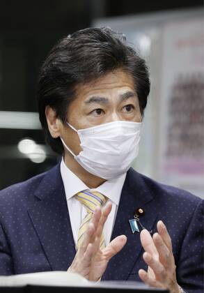 Japan health ministry panel greenlights 1st COVID-19 vaccine Japanese health minister Norihisa Tamura speaks to reporters in Tokyo on Feb. 12, 2021, after a panel of his ministry greenlit the coronavirus vaccine developed by Pfizer Inc. to become the first approved for use in Japan. 