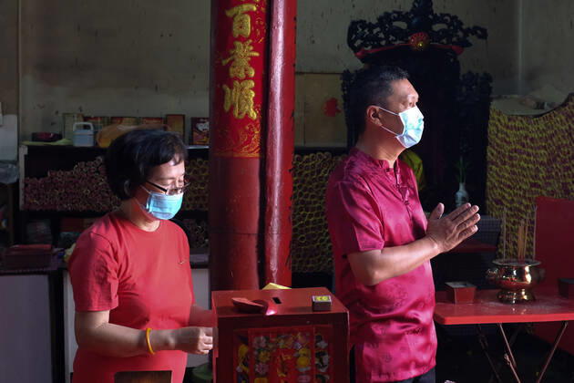 February 12, 2021: Visitors offering prayers at a temple in Seremban, Negeri Sembilan while wearing face masks during the COVID-19 pandemic. This yearÃ¢â‚¬â ¢s Lunar New Year festivities are subdued due to the strict measures imposed such as no interstate or inter-district travels as well as no mass gathering to halt the spread of the pandemic...Spring Festival or the Lunar New Year, is the festival that celebrates the beginning of a new year on the traditional lunisolar Chinese calendar. - ZUMAn290 20210212_zip_n290_002 Copyright: xFuadxNizamx