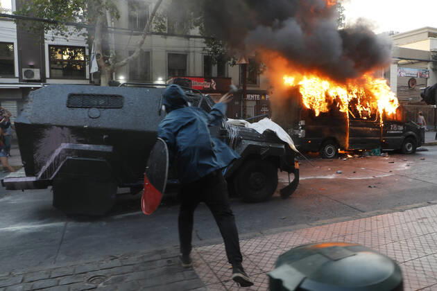Santiago, February 12, 2021 Carabineros van is set on fire during the protest by prisoners of the social outbreak in the center of the capital during the coronavirus pandemic Dragomir Yankovic Aton Chile, Santiago Chile Aton 488474  Copyright: DRAGOMIRxYANKOVIC ATONxCHILE