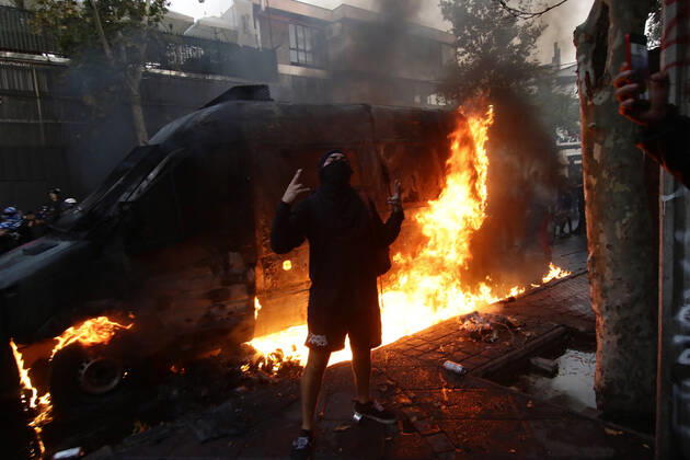 Santiago, February 12, 2021 Carabineros van is set on fire during the protest by prisoners of the social outbreak in the center of the capital during the coronavirus pandemic Javier Salvo Aton Chile, Santiago Chile Aton 488482  Copyright: JAVIERxSALVO ATONxCHILE