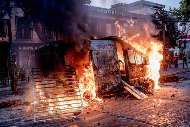 February 12, 2021, Santiago, Chile: Chilean police vehicle seen set ablaze by protesters during protests against police brutality in Santiago..Several protesters took to the streets in a protest that saw a police vehicle being burnt down following the death of a street artist who was shot by police in the city of Panguipulli after he refused to co-operate with a police search. Santiago Chile - ZUMAs197 20210212_zaa_s197_240 Copyright: xPabloxRojasxMadariagax