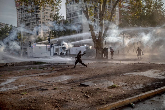 February 12, 2021, Santiago, Region Metropolitana, Chile: A protester confront the police during protests against police brutality in Santiago..Several protesters took to the streets in a protest against President Sebastian Pinera s government, attacking and burning a police vehicle hence injuring an officer following the death of a street artist who was shot by police in the city of Panguipulli after he refused to co-operate with a police search. Santiago Chile - ZUMAs197 20210212_zaa_s197_264 Copyright: xFelipexFigueroax