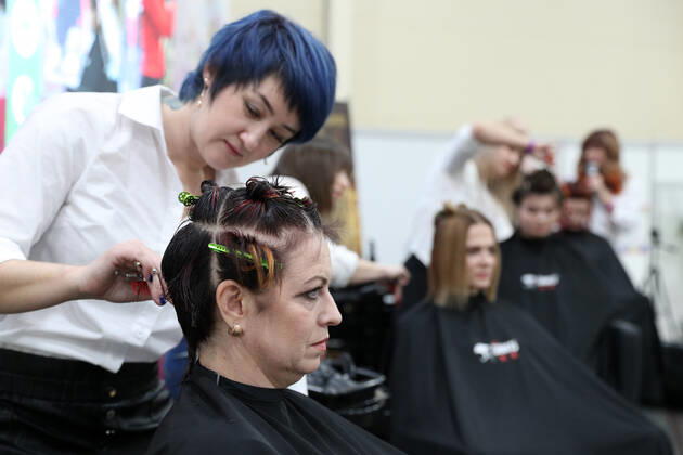 ROSTOV-ON-DON, RUSSIA - FEBRUARY 13, 2021: A woman tended to by a hairdresser during the Sharm Charm beauty industry exhibition at the DonExpocentre. Erik Romanenko TASS  TS0F6B5E