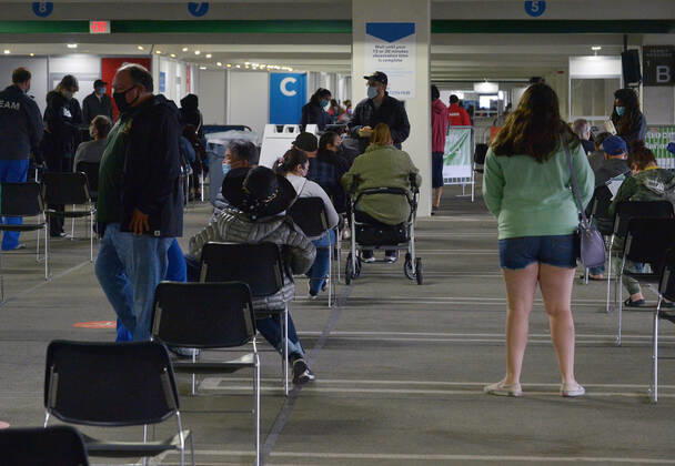 Local residents wait in the observation area after receiving a COVID-19 shot at the Cal Poly Pomona mass vaccination site in Pomona, California on Saturday, February 13, 2021. A 78-year-old woman passed away unexpectedly Friday shortly after receiving Pfizer s version of the COVID-19 vaccine at the Kaiser-run site. The patient s family said she had a history of heart illness. Her cause of death was yet to be determined, but the Los Angeles County Department of Public Health said by email that there were no signs of allergic or anaphylactic reactions. Her death does not appear to be related to the vaccine, it said.  LAP2021021310 JIMxRUYMEN