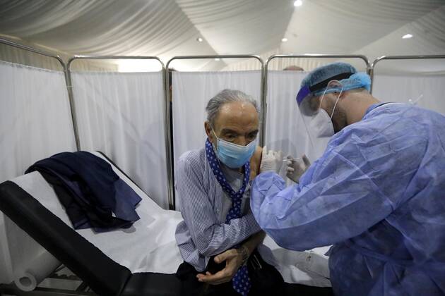 (210214) -- BEIRUT, Feb. 14, 2021 -- An elderly staff member of the Saint George Hospital receives a dose of vaccine against COVID-19 in Beirut, Lebanon, on Feb. 14, 2021. Lebanon launched on Sunday its vaccination campaign by starting with employees in the health sector after receiving, a day earlier, 28,500 vaccines from Pfizer-BioNTech, LBCI local TV channel reported. ) LEBANON-BEIRUT-COVID-19-VACCINATION BilalxJawich 