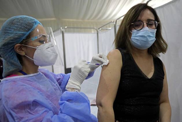 (210214) -- BEIRUT, Feb. 14, 2021 -- A staff member of the Saint George Hospital receives a dose of vaccine against COVID-19 in Beirut, Lebanon, on Feb. 14, 2021. Lebanon launched on Sunday its vaccination campaign by starting with employees in the health sector after receiving, a day earlier, 28,500 vaccines from Pfizer-BioNTech, LBCI local TV channel reported. ) LEBANON-BEIRUT-COVID-19-VACCINATION BilalxJawich 