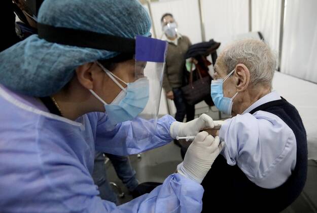 (210214) -- BEIRUT, Feb. 14, 2021 -- An elderly staff member of the Saint George Hospital receives a dose of vaccine against COVID-19 in Beirut, Lebanon, on Feb. 14, 2021. Lebanon launched on Sunday its vaccination campaign by starting with employees in the health sector after receiving, a day earlier, 28,500 vaccines from Pfizer-BioNTech, LBCI local TV channel reported. ) LEBANON-BEIRUT-COVID-19-VACCINATION BilalxJawich 