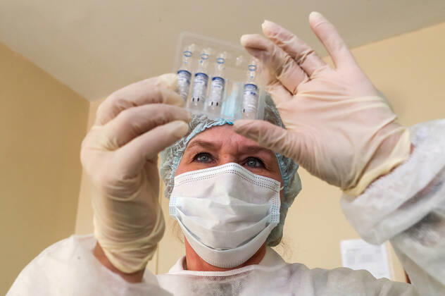 ST PETERSBURG, RUSSIA â€” FEBRUARY 15, 2021: A medical worker looks at vials containing the Gam-COVID-Vac vaccine (under the brand name of Sputnik V) while vaccinating people against COVID-19 at No 7 Neuropsychiatric Boarding School. Alexander Demianchuk TASS  TS0F6D07