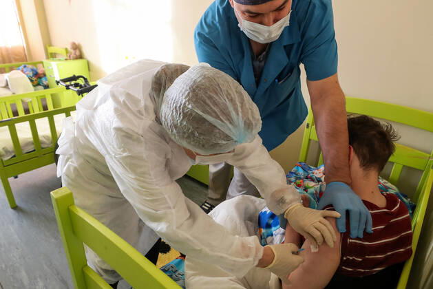 ST PETERSBURG, RUSSIA â€” FEBRUARY 15, 2021: A medical worker injects a patient with the Gam-COVID-Vac vaccine (under the brand name of Sputnik V) at No 7 Neuropsychiatric Care Home. Alexander Demianchuk TASS  TS0F6D12