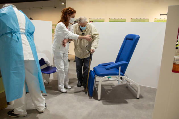 Italy: New area for anti-Covid vaccination in Rome A nurse helps a patient sit down before vaccination Rome Italy Copyright: MatteoxNardone