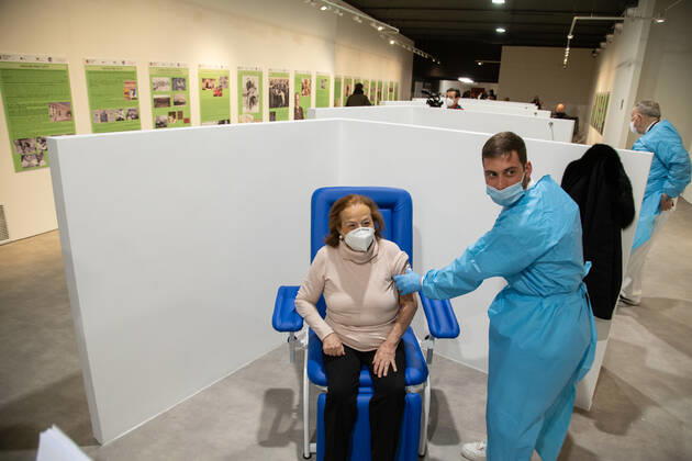 Italy: New area for anti-Covid vaccination in Rome A nurse vaccinates a patient over 80 in the new area dedicated to vaccinations in the Ennio Morricone Auditorium in Rome Rome Italy Copyright: MatteoxNardone