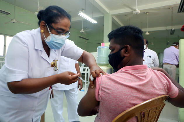 (210215) -- COLOMBO, Feb. 15, 2021 -- A man receives a dose of COVID-19 vaccine in Colombo, Sri Lanka, Feb. 15, 2021. Sri Lankan President Gotabaya Rajapaksa on Monday instructed health authorities to start vaccinating members of the general public in the country s Western Province with the Oxford Astra Zeneca against the COVID-19 virus. Officials said they had started vaccinating those who are at high risk of exposure of the virus, such as port workers, private hospital staff members and even garbage collectors who were based in Western Province. (Photo by Xinhua) SRI LANKA-COLOMBO-COVID-19-VACCINATION AjithxPerera 