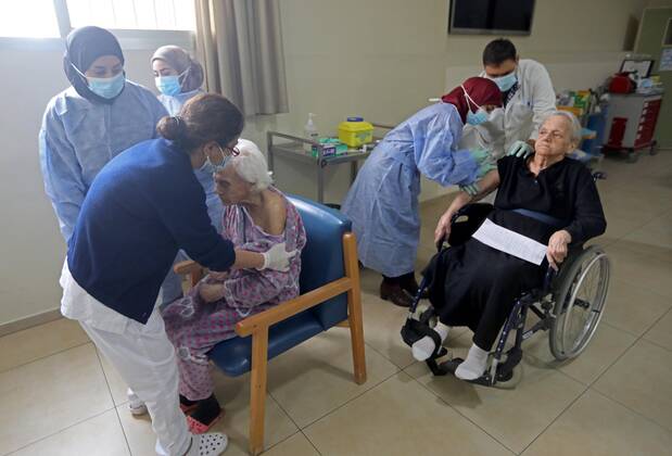 (210215) -- BEIRUT, Feb. 15, 2021 -- Elderly people receive the COVID-19 vaccine at a nursing home in Beirut, Lebanon on Feb. 15, 2021. Lebanon recorded on Monday 1,793 new COVID-19 cases, raising the total number of infections to 340,861, the Health Ministry reported. Lebanon launched on Sunday its vaccination campaign against COVID-19. ) LEBANON-BEIRUT-COVID-19-VACCINATION-ELDERLY PEOPLE BilalxJawich 