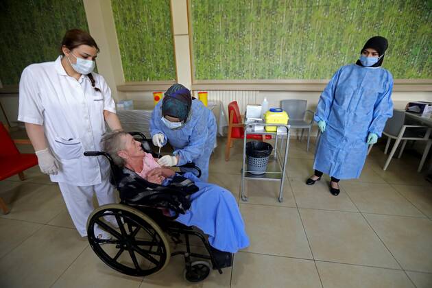 (210215) -- BEIRUT, Feb. 15, 2021 -- An elderly woman receives the COVID-19 vaccine at a nursing home in Beirut, Lebanon on Feb. 15, 2021. Lebanon recorded on Monday 1,793 new COVID-19 cases, raising the total number of infections to 340,861, the Health Ministry reported. Lebanon launched on Sunday its vaccination campaign against COVID-19. ) LEBANON-BEIRUT-COVID-19-VACCINATION-ELDERLY PEOPLE BilalxJawich 