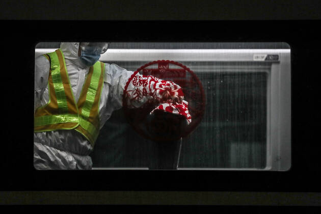 (210216) -- SHENYANG, Feb. 16, 2021 -- Wang Tong, a mechanic of China Railway Shenyang Bureau, disinfects a train in Shenyang, capital of northeast China s Liaoning Province, Feb. 14, 2021. Since December last year, some areas in China s northeastern Heilongjiang, Jilin, and Liaoning Provinces reported newly confirmed COVID-19 cases. Related areas responded immediately according to epidemic prevention requirements. Mass nucleic acid testing were conducted in key areas in an effort to stem the spread of the coronavirus. Recently, no new confirmed COVID-19 cases have been reported here for several days. During the Spring Festival vacation, many workers stick to their posts to make sure people can celebrate the festival safely. ) CHINA-SPRING