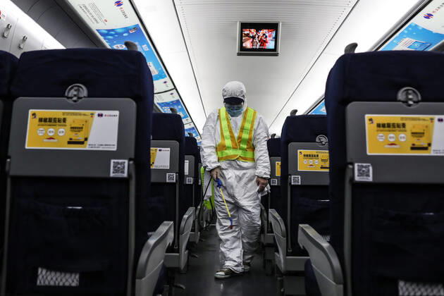(210216) -- SHENYANG, Feb. 16, 2021 -- Wang Tong, a mechanic of China Railway Shenyang Bureau, disinfects a train in Shenyang, capital of northeast China s Liaoning Province, Feb. 14, 2021. Since December last year, some areas in China s northeastern Heilongjiang, Jilin, and Liaoning Provinces reported newly confirmed COVID-19 cases. Related areas responded immediately according to epidemic prevention requirements. Mass nucleic acid testing were conducted in key areas in an effort to stem the spread of the coronavirus. Recently, no new confirmed COVID-19 cases have been reported here for several days. During the Spring Festival vacation, many workers stick to their posts to make sure people can celebrate the festival safely. ) CHINA-SPRING