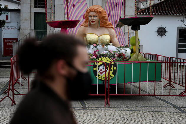 February 16, 2021, Lisbon, Portugal: A men wearing a facial protective mask walks by a carnival float on display in Loures, on the outskirts of Lisbon, Portugal, on February 16, 2021. Portugal s carnival parades and festivities had to be canceled as part of ongoing lockdown measures against COVID-19 pandemic, but some municipalities have adapted and asked revelers to party in their windows or online. Lisbon Portugal - ZUMAf123 20210216_zap_f123_001 Copyright: xPedroxFiuzax