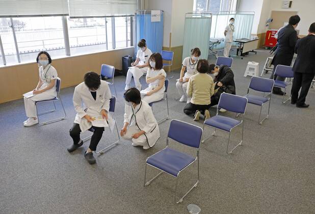 Japan begins COVID-19 vaccine to health workers Health workers at the Tokyo Medical Center are pictured at their hospital in Tokyo s Meguro Ward on Feb. 17, 2021, after they were administered the first COVID-19 vaccines under Japan s anti-coronavirus vaccination project. The country is starting with an initial group of 40,000 health workers before expanding the rollout to the elderly and people with preexisting conditions. (Pool photo) 
