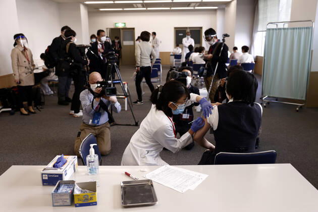 February 17, 2021, Tokyo, Japan: Members of the media look on as a medical worker (R) receives a dose of the COVID-19 vaccine as the country launches its inoculation campaign at the Tokyo Medical Center in Tokyo on February 17, 2021. Tokyo Japan - ZUMAz114 20210217_zih_z114_019 Copyright: xPOOLx