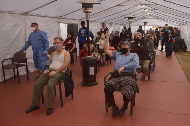 Local residents wait their turn to receive a COVID-19 vaccination shot at the Kedren Community Health Center in South Los Angeles on Tuesday, February 16, 2021. To boost vaccination among people of color, L.A. county plans more sites, better messaging and access to transit. Black, Latino and Native American seniors are being vaccinated at lower rates than other groups.  LAP2021021608 JIMxRUYMEN