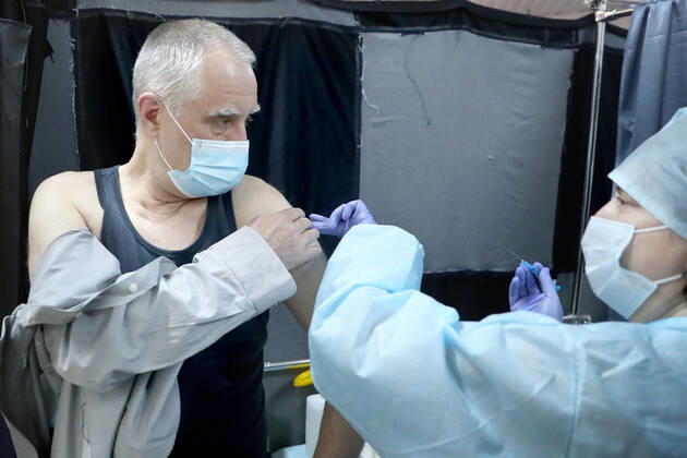 YEKATERINBURG, RUSSIA - FEBRUARY 17, 2021: A man receives an injection of the Gam-COVID-Vac (Sputnik-V) vaccine against COVID-19 in a mobile vaccination unit set up at the Dirizhabl Airship shopping centre, vaccination free of charge, no prior appointment required. Donat Sorokin TASS  TS0F7013