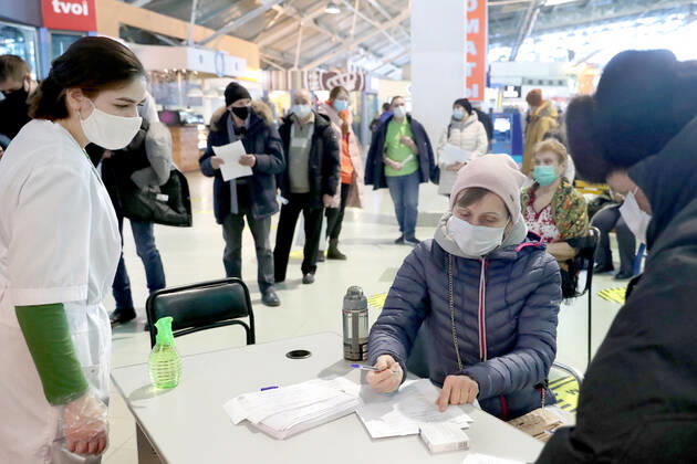 YEKATERINBURG, RUSSIA - FEBRUARY 17, 2021: Processing documents outside a mobile COVID-19 vaccination unit set up at the Dirizhabl Airship shopping centre, injections of the Gam-COVID-Vac (Sputnik-V) free of charge, no prior appointment required. Donat Sorokin TASS  TS0F7017