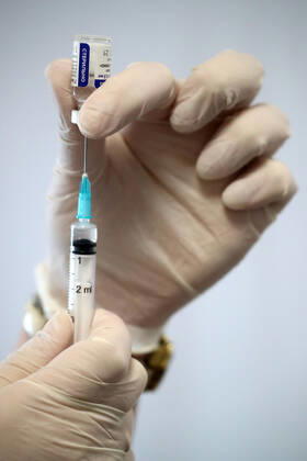 MOSCOW, RUSSIA â€“ FEBRUARY 17, 2021: A nurse fills a syringe with the Gam-COVID-Vac vaccine (under the brand name of Sputnik V) at a new temporary COVID-19 vaccination site in the VDNKh Exhibition Centre. A mobile vaccination team is providing vaccines free of charge and without prior sign-up. Since the start of the pandemic, Moscow has confirmed more than 960,600 cases of COVID-19. Since late January, the number of new confirmed cases has been increasing in the Russian capital by more than 1,200 daily. Sergei Savostyanov TASS  TS0F700E
