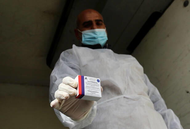 February 17, 2021, Rafah, Gaza Strip, Palestinian Territory: Palestinian health workers unload the first arriving shipment of doses of Russia s Sputnik V vaccine for COVID-19 coronavirus disease, on the Palestinian side of the Kerem Shalom border crossing south of Rafah in the southern Gaza Strip on February 17, 2021 Rafah Palestinian Territory - ZUMAap3_ 20210217_zaf_ap3_099 Copyright: xAshrafxAmrax